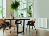 Stylish and botany interior of dining room with design craft wooden table, chairs, furniture, a lof of plants, window, poster map and elegant accessories in modern home decor. Template.